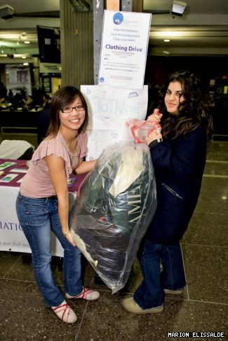 Ginny Kwan and Sabrina Rashid (VP Members) hoist donations at the drive.